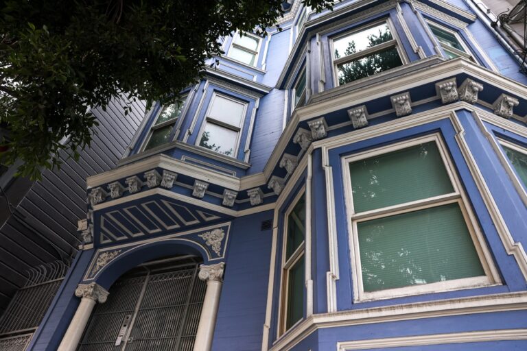 A blue building with white trim Description automatically generated