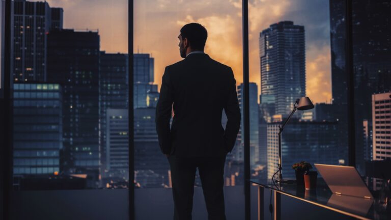 Thoughtful,Young,Businessman,In,A,Perfect,Tailored,Suit,Standing,In