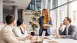 Female,Manager,Standing,At,Meeting,Room,And,Having,Briefing,With