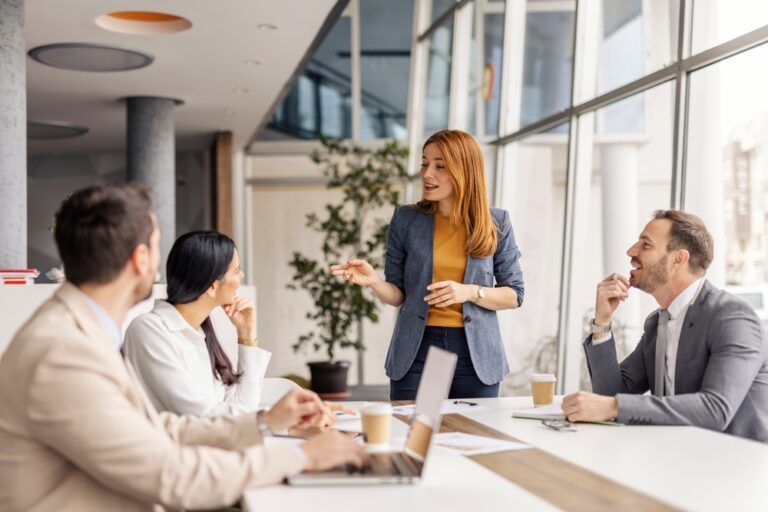 Female,Manager,Standing,At,Meeting,Room,And,Having,Briefing,With